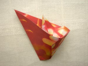 folding a red origami flower