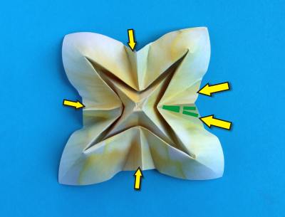 folding a lovely white coloured origami flower