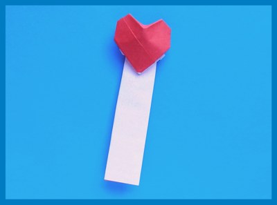 white origami bookmark with a large red heart
