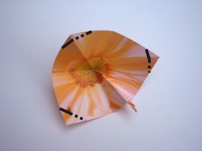 folding an orange origami flower folding an orange origami flower
