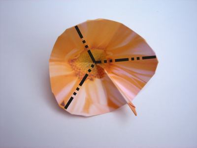 folding an orange origami flower folding an orange origami flower