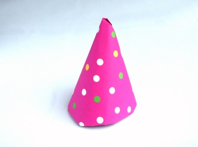 origami party hat with polka dot pattern