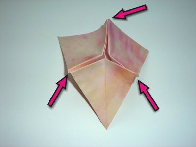 folding a pink origami flower