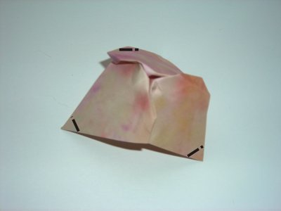 folding a pink origami flower