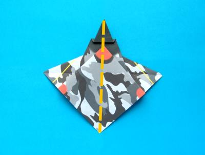 folding an origami plane - stunt fighter