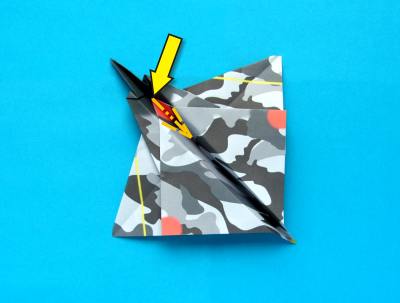 folding an origami plane - stunt fighter