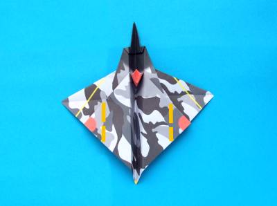 folding an origami plane - stunt fighter
