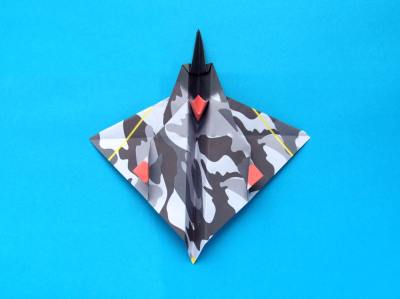 folding an origami plane - stunt fighter
