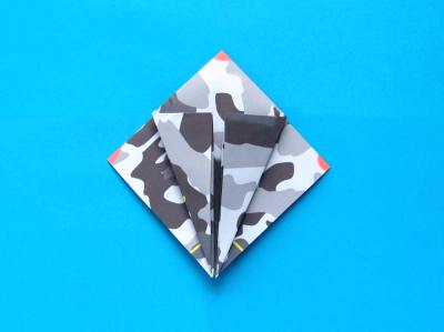 folding an origami plane - stunt fighter