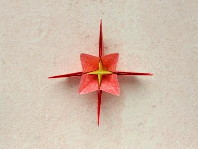 red origami flower with a yellow center