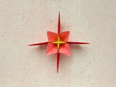 red origami flower with a yellow center red origami flower with a yellow center