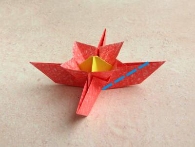 red origami flower with a yellow center