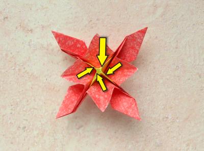 red origami flower with a yellow center red origami flower with a yellow center