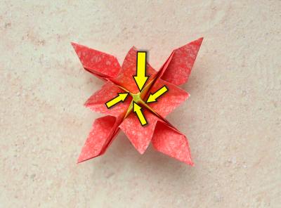 red origami flower with a yellow center