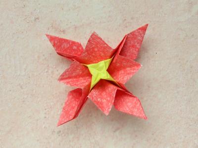 red origami flower with a yellow center