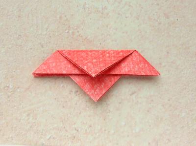 red origami flower with a yellow center red origami flower with a yellow center