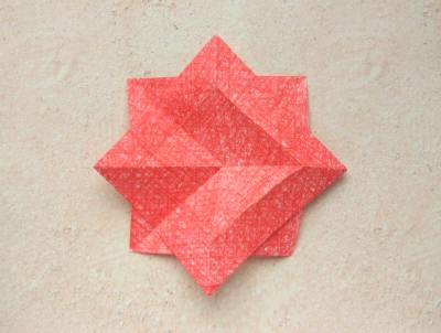 red origami flower with a yellow center