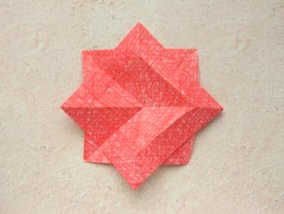 red origami flower with a yellow center red origami flower with a yellow center