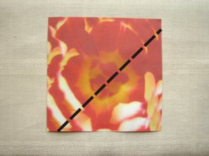 folding a red origami flower