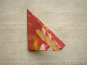 folding a red origami flower folding a red origami flower