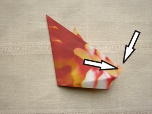 folding a red origami flower folding a red origami flower