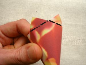 folding a red origami flower folding a red origami flower