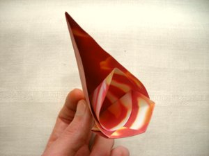 folding a red origami flower folding a red origami flower