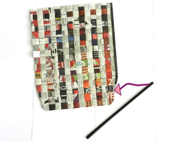 Make a woven newspaper clutch purse