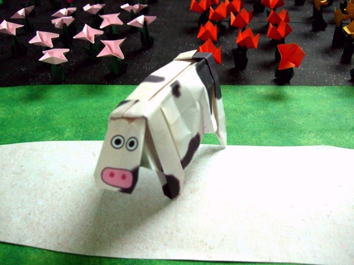 origami cow surrounded by paper flowers origami cow surrounded by paper flowers