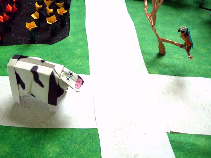 origami cow standing at a cross road origami cow standing at a cross road