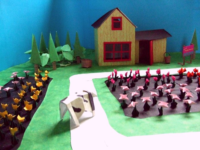 origami cow looking at a cute paper house origami cow looking at a cute paper house