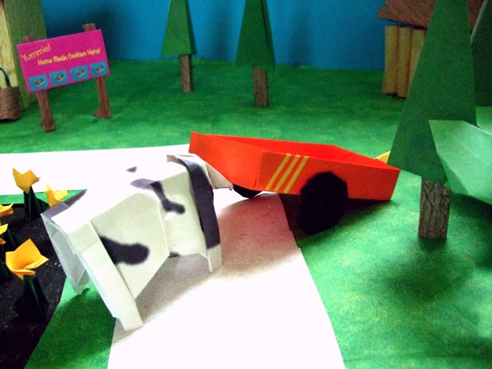 cow pushing a kirigami wagon cow pushing a kirigami wagon