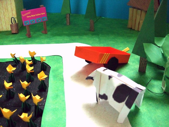 funny cow looking at a kirigami wagon funny cow looking at a kirigami wagon