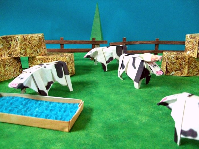funky origami cows in a paper scenery