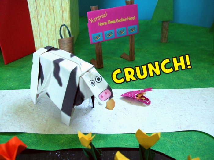 cow eating an origami cookie cow eating an origami cookie