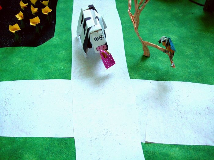 cow with a bag of origami cookies in his mouth cow with a bag of origami cookies in his mouth