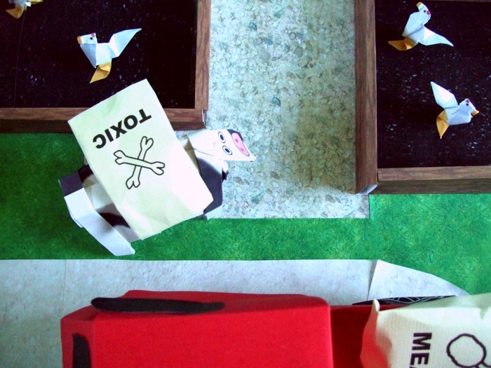 cow standing in front of an origami chicken farm cow standing in front of an origami chicken farm