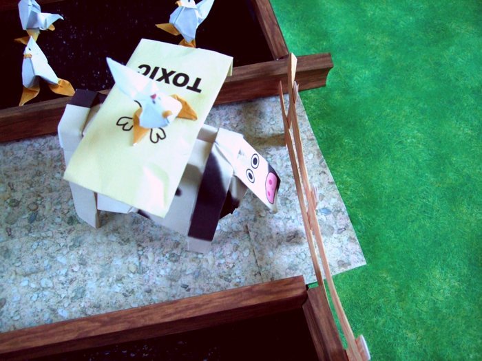 origami chicken standing on a bag with toxic origami chicken standing on a bag with toxic