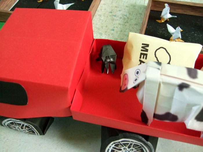 cow looking at a large origami spider cow looking at a large origami spider