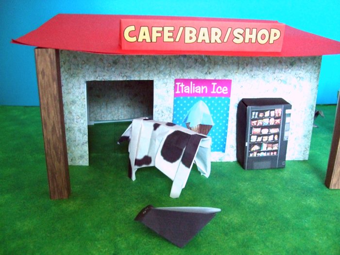 cow looking at a kirigami shop cow looking at a kirigami shop