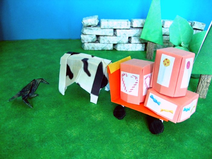 cow pushing a kirigami wagon packed with candy boxes cow pushing a kirigami wagon packed with candy boxes