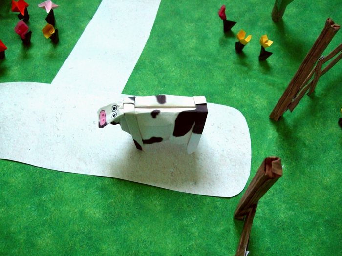 origami cow walking on a path origami cow walking on a path