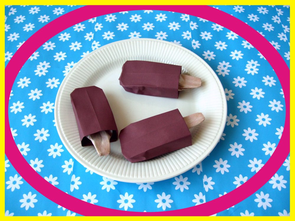 card with origami chocolate popsicles on a plate