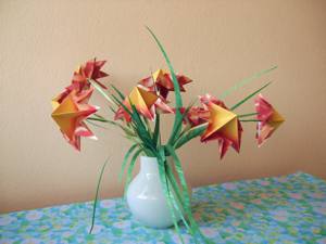 Card with red origami flowers in a vase