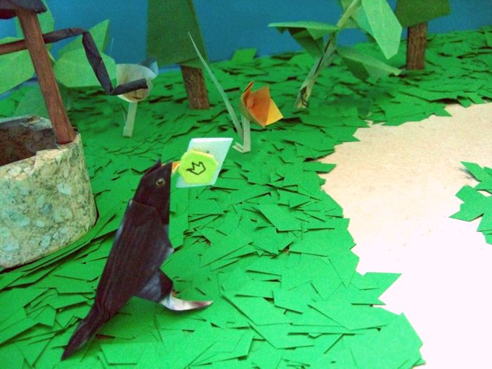 origami bird with a coin and a letter in his mouth origami bird with a coin and a letter in his mouth