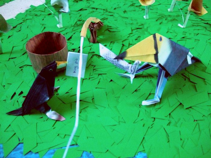 tucan with an origami fish in his mouth tucan with an origami fish in his mouth