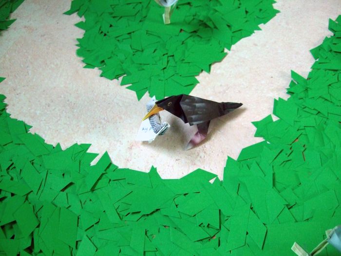 birdie with an origami fish in his mouth birdie with an origami fish in his mouth