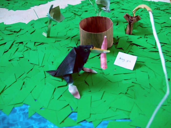 little bird eating an origami worm little bird eating an origami worm