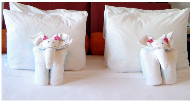 cute towel origami elephants on a bed