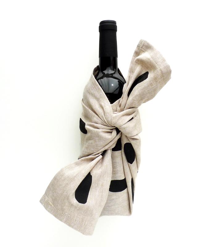 Wine bottle wrapped in a tea towel